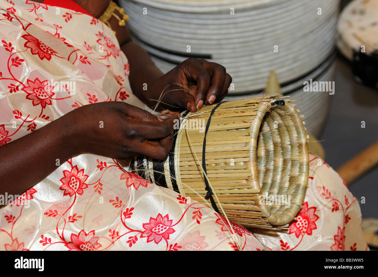 Skillful hands of an African woman producing a bast basket, Rwanda Stock Photo