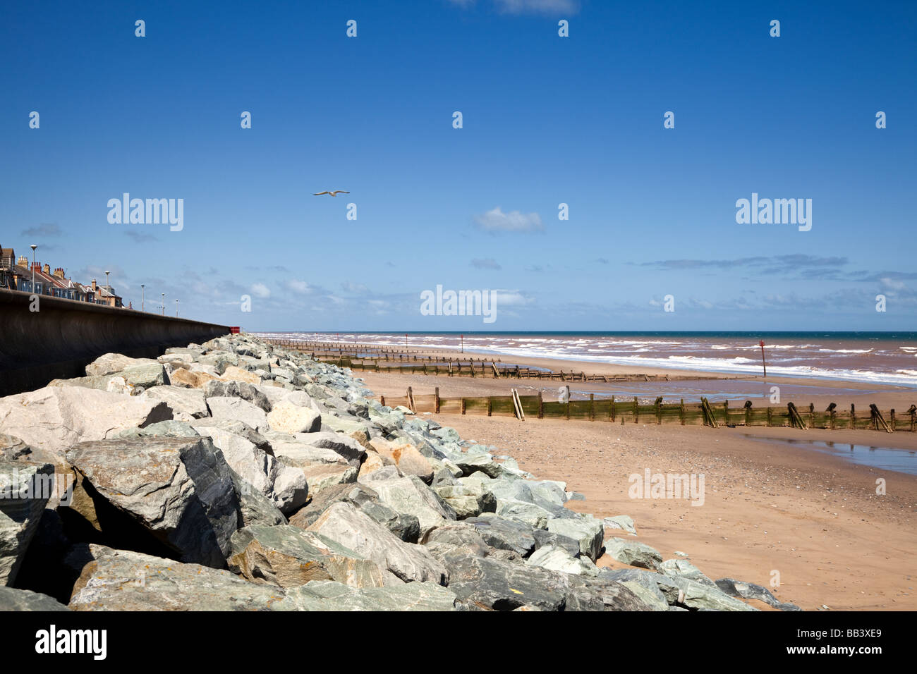 Granite boulder and wooden breakwaters protection for the sea wall at Withernsea East Yorkshire England UK Stock Photo