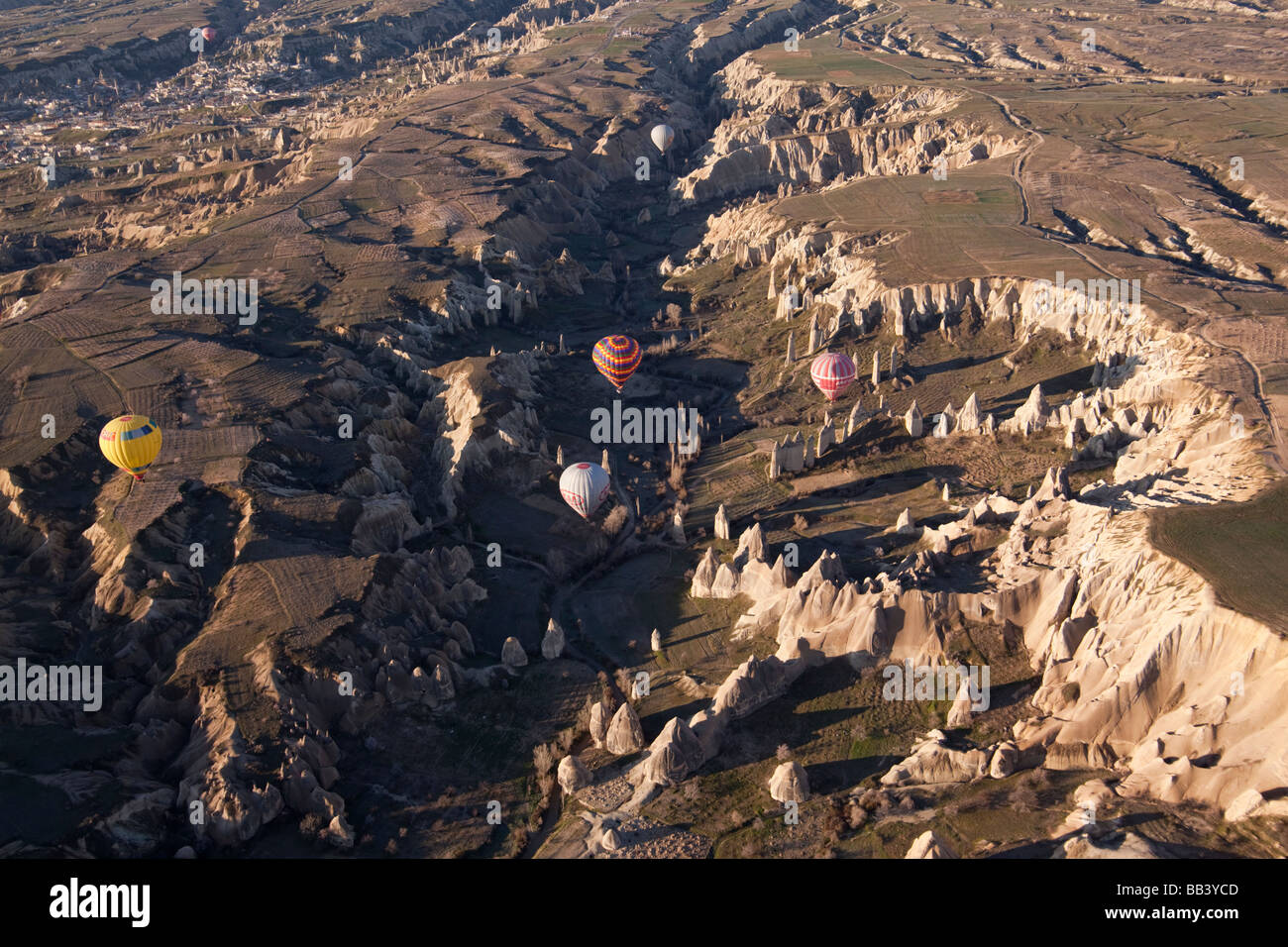 Aerial view of hot air balloons over rough terrain in Cappadocia Turkey Stock Photo
