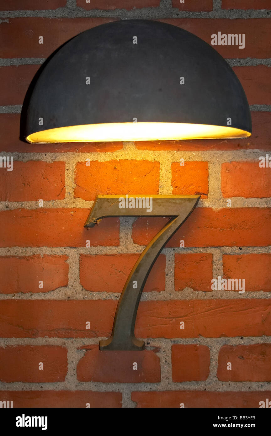 alight number seven on red brick wall Stock Photo