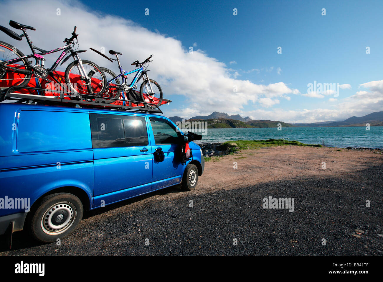 blue van with bikes & canoes parked overlooking Kyle of Tongue Sutherland Northern Scotland Great Britain UK Stock Photo