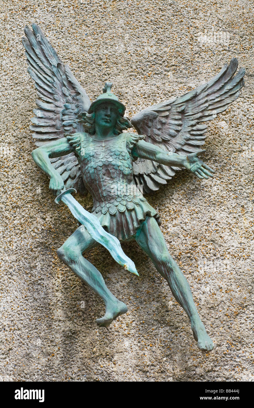 Mostly fibreglass sculpture of the archangel St Michael with sword. South side of  tower at St. Michael's Church, High Street, Lewes. East Sussex. UK Stock Photo