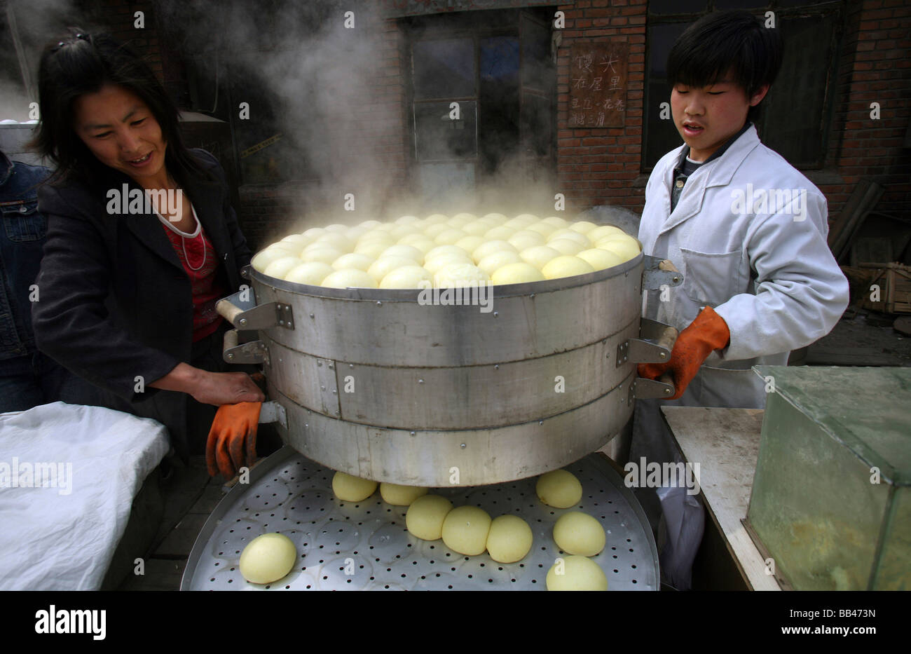 Chinese workers carry a steamer of Stock Photo Alamy