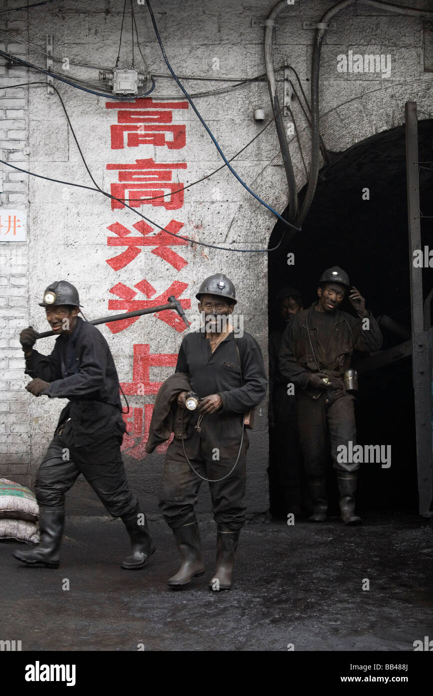 Chinese miners emerge from a coal mine after the work day, Liulin, Shanxi, China. Stock Photo