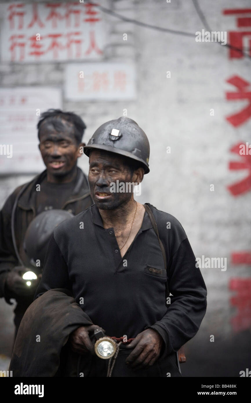 Miners emerge from a coal mine after a days work, Liulin, Shanxi, China. Stock Photo