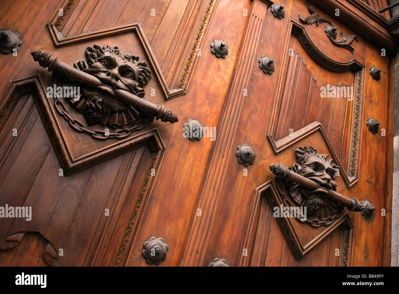 Menacing wooden sculpted lion heads on the doors of a Spanish colonial church in downtown Quito, Ecuador. Stock Photo