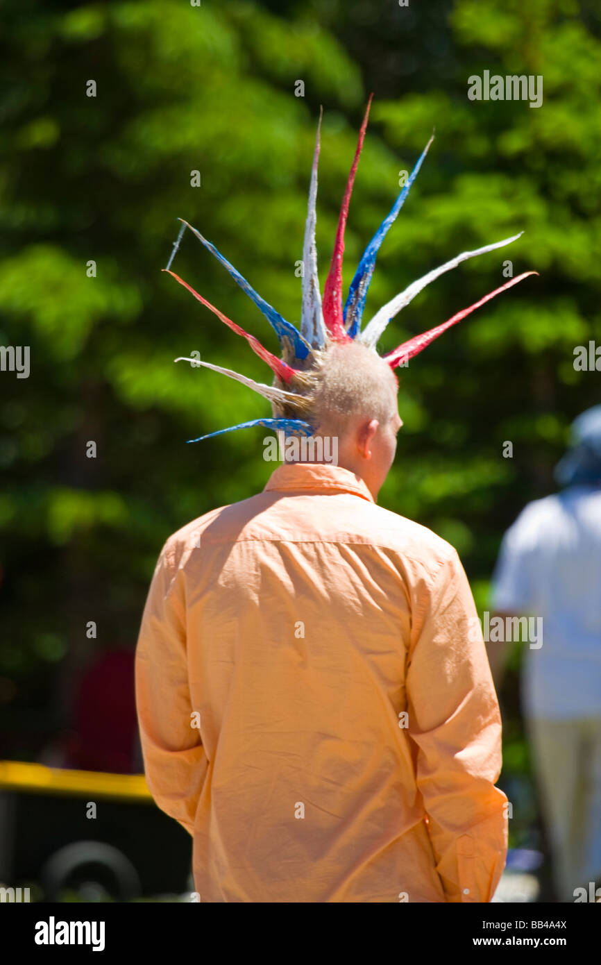 USA, Colorado, Frisco. young man with spiked hair in red, white, and blue colors watching July Fourth parade. Stock Photo