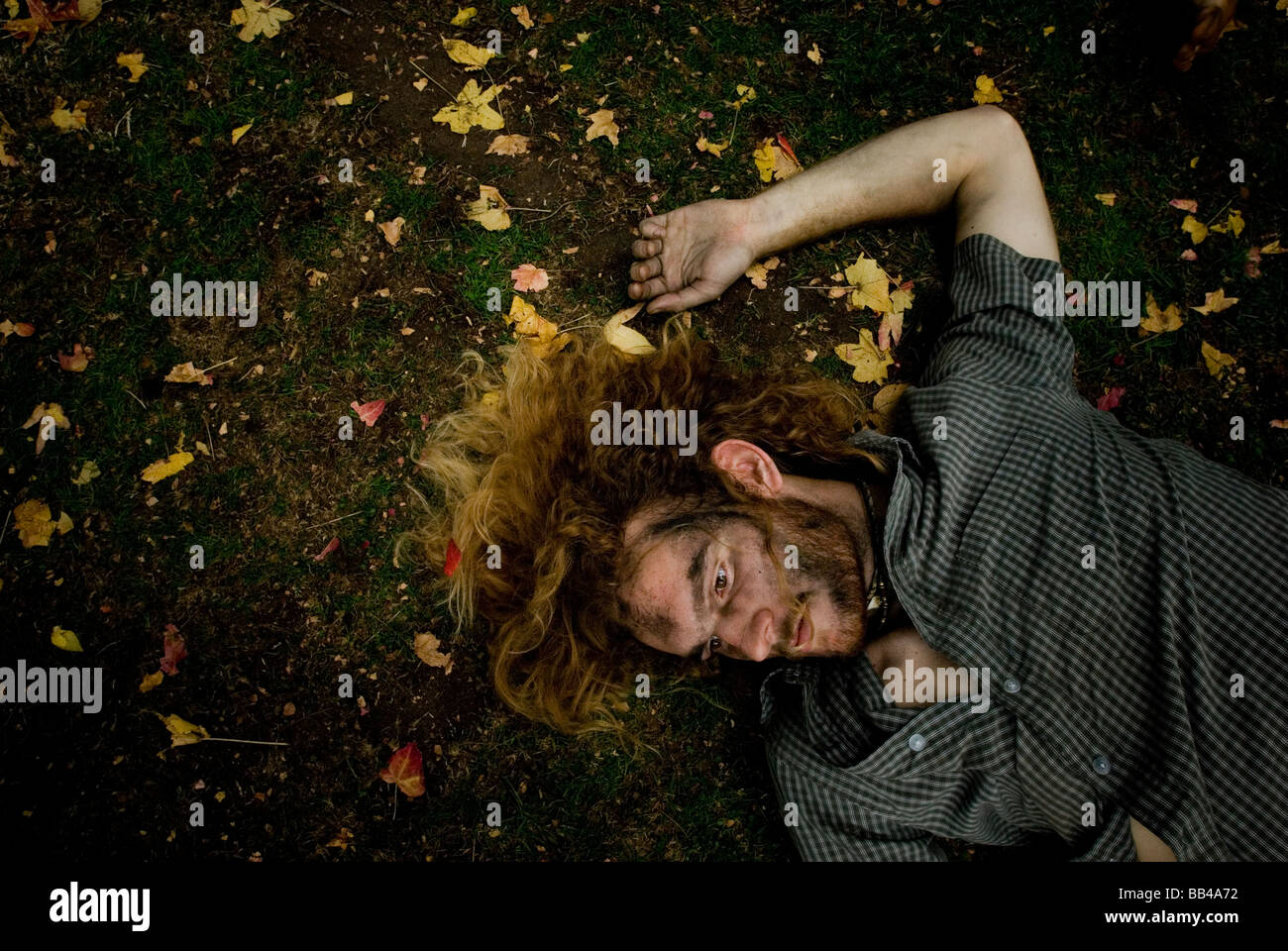 A man pretending to be a zombie lays still on the ground at the largest simultaneous reenactment of Michael Jackson's 'Thriller' Stock Photo