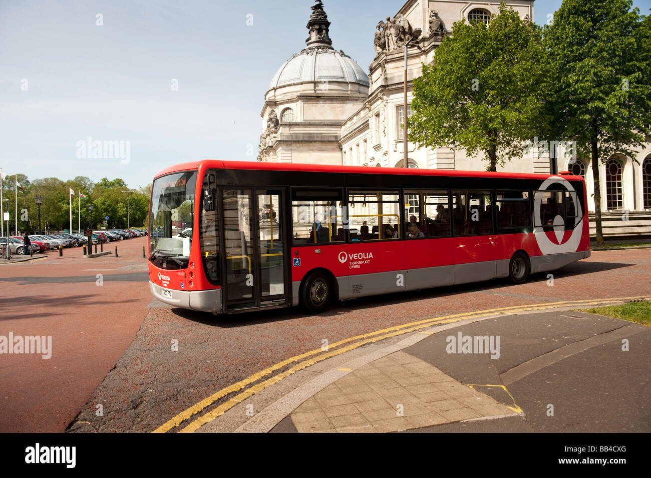 a red single decker Veolia transport company bus in Cardiff City centre Wales UK Stock Photo