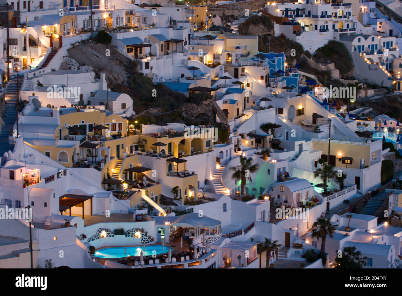 Europe, Greece, Santorini, Firostefani. Close-up of cliffside villas with lights coming on at nightfall. Stock Photo