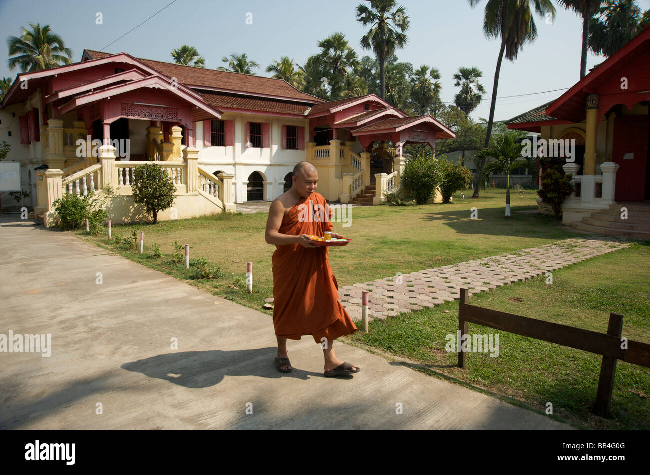 A monk walking through the grounds of a Burmese Temple in Chiang Mai Stock Photo