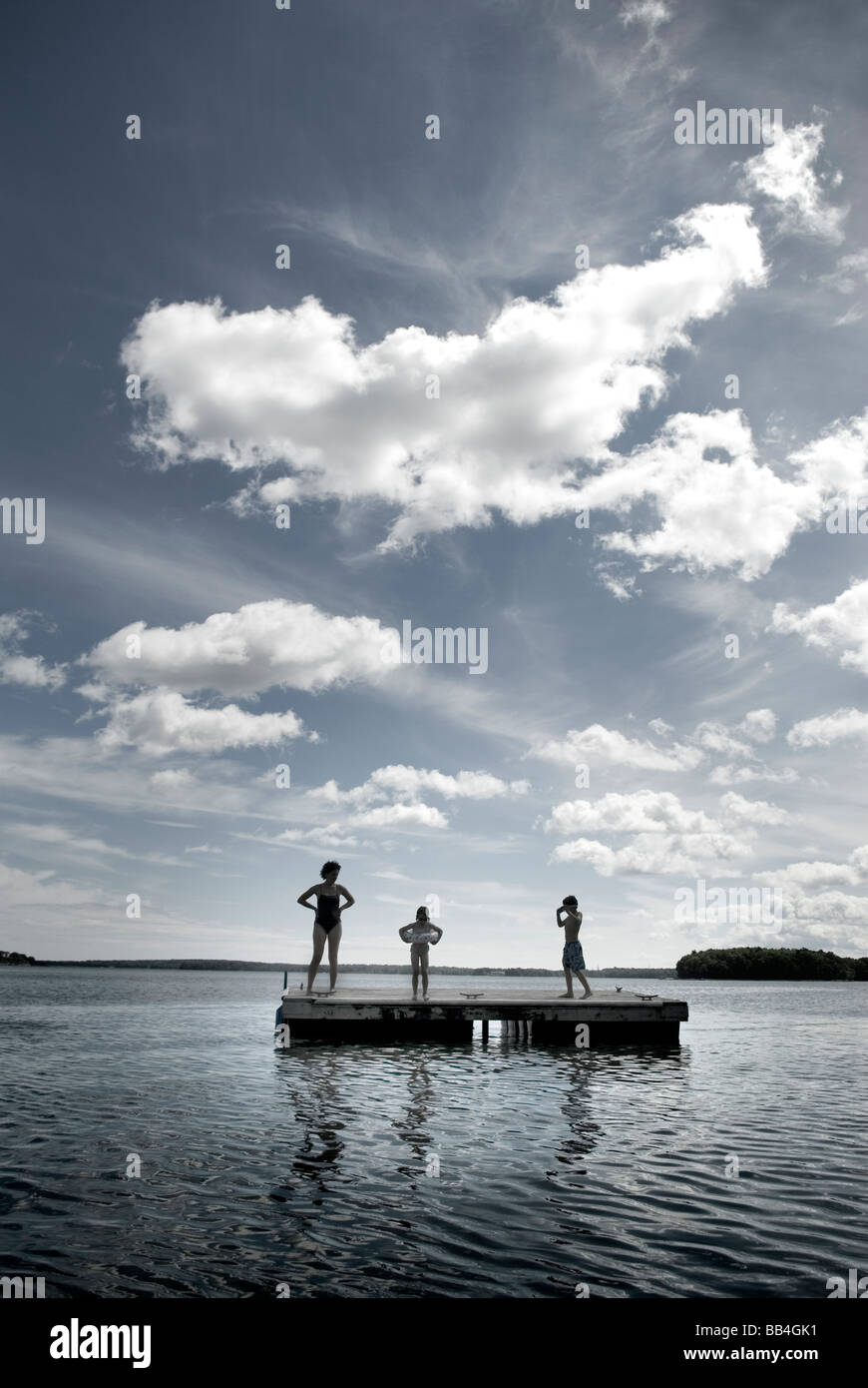 Family plays on floating raft in Casco Bay, Maine, New England. Stock Photo