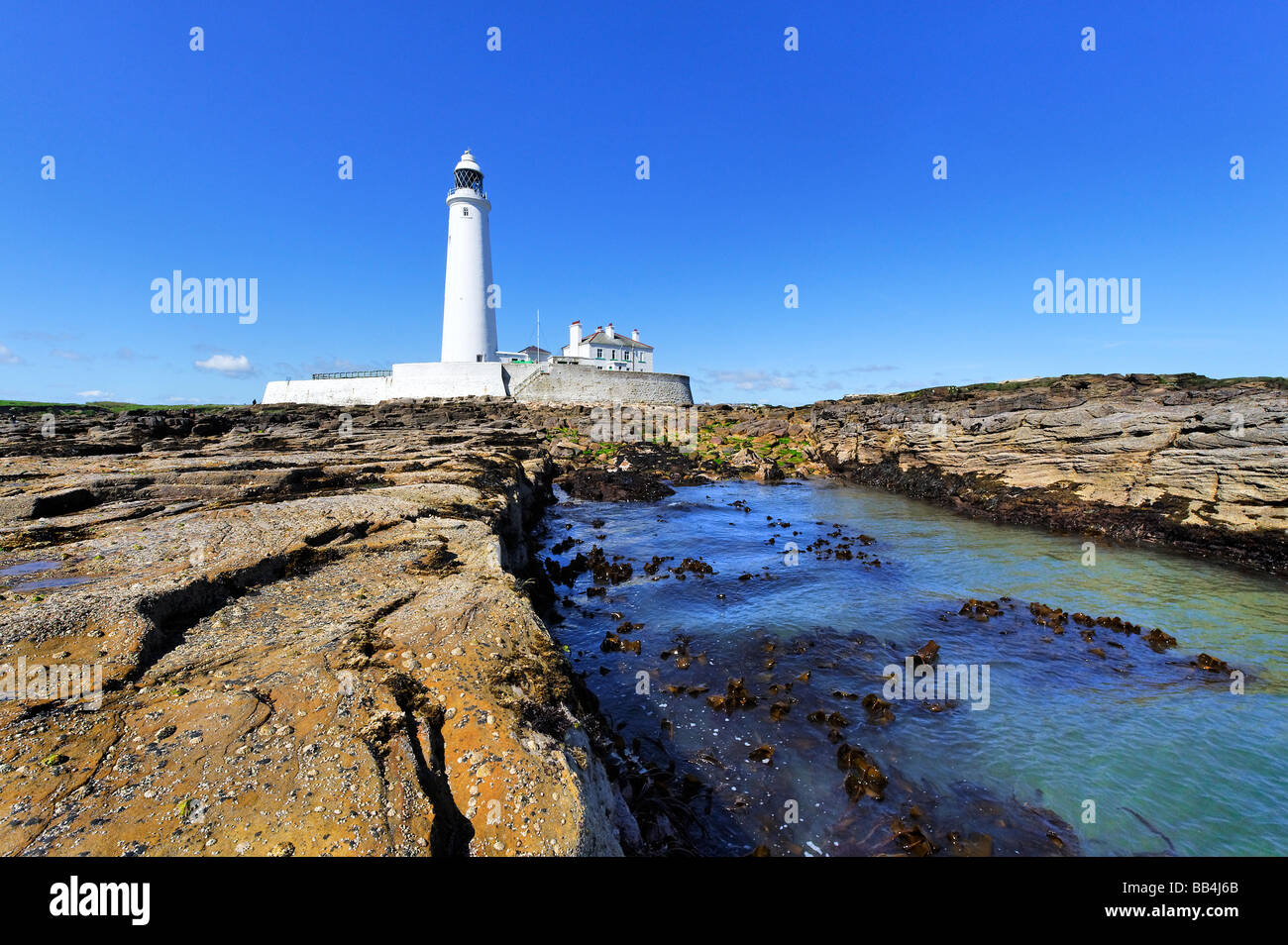 Lighthouse viewed from shoreline Stock Photo