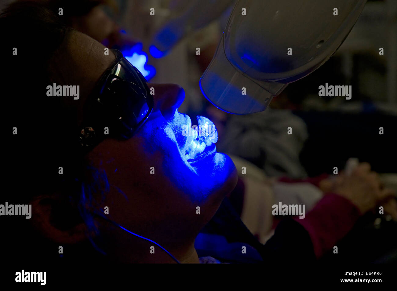 People getting a teeth whitening procedure done at booth at the Florida