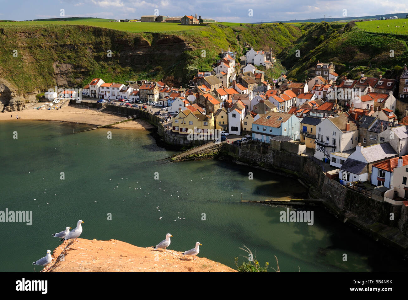 The coastal village of Staithes nestled beneath eroding cliffs on the Yorkshire coast England UK Stock Photo