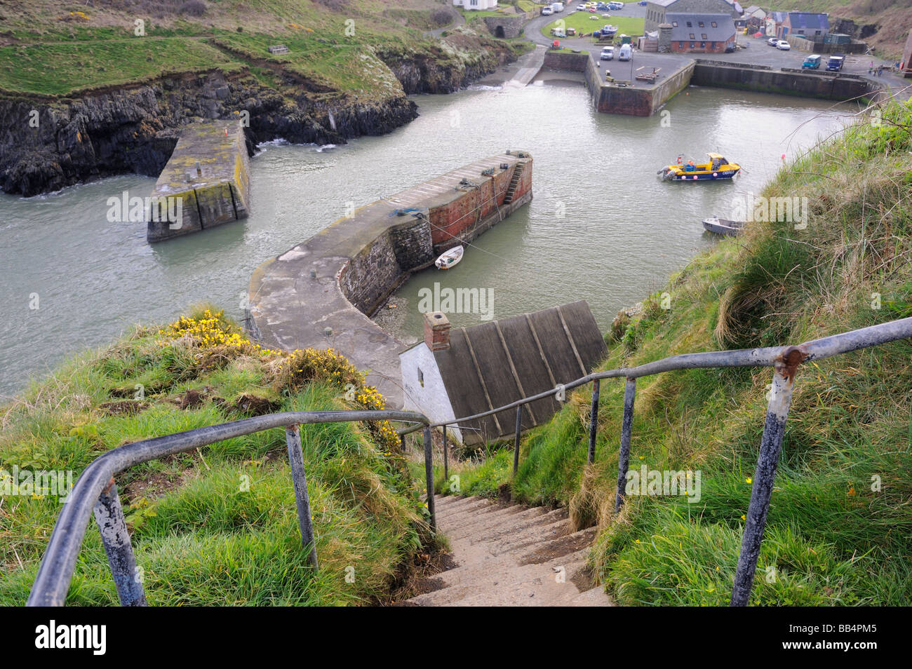 A view down the steps leading to the harbour at Porthgain on the Pembrokeshire coast path, Wales, UK Stock Photo