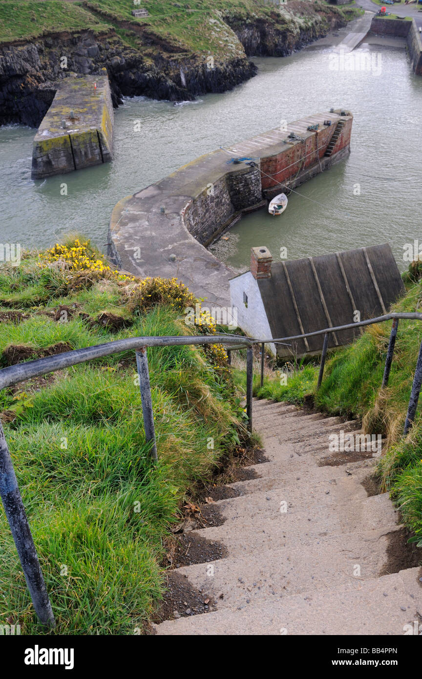 A view down the steps leading to the harbour at Porthgain on the Pembrokeshire coast path, Wales, UK Stock Photo