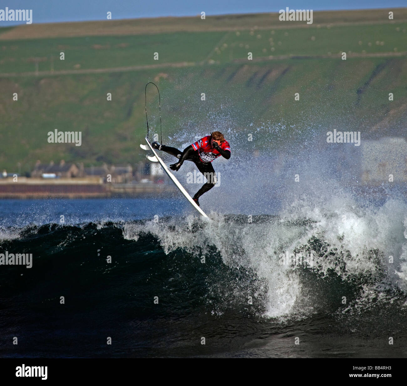 Surfing competitor takes to the air in O'Neill 'Cold Water Classic' competition at Thurso East, Thurso, Caithness, Scotland Stock Photo