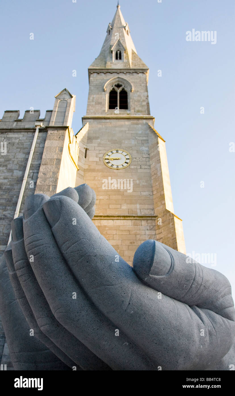 Europe, Ireland, Ennis. Stone sculpture of a pair of hands seem to hold