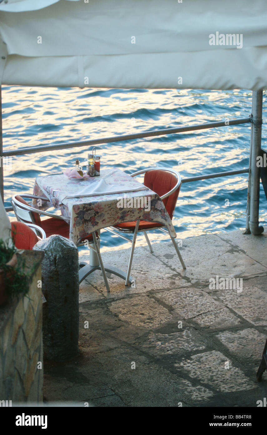 Empty restaurant table for two persons in the port of Veli Losinj, Mali Losinj, Croatia Stock Photo