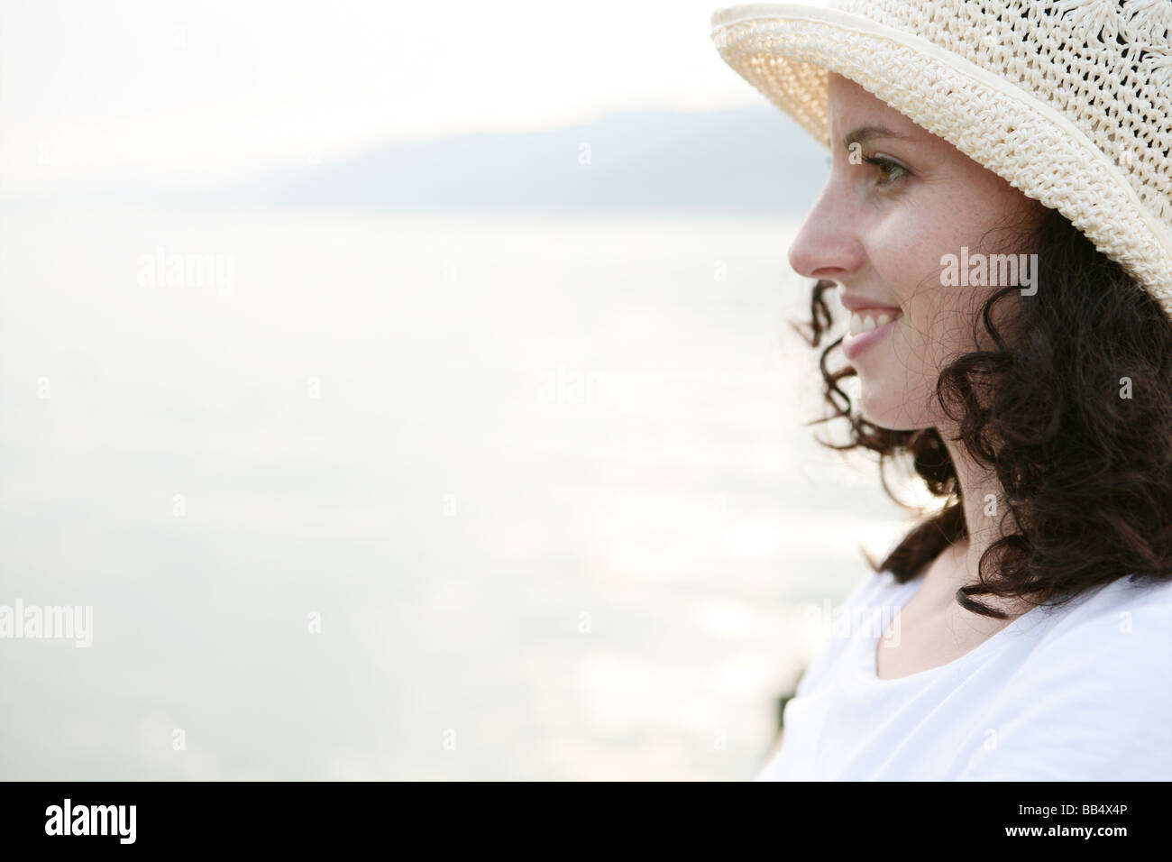 Portrait of woman smiling at the lakeside Stock Photo - Alamy