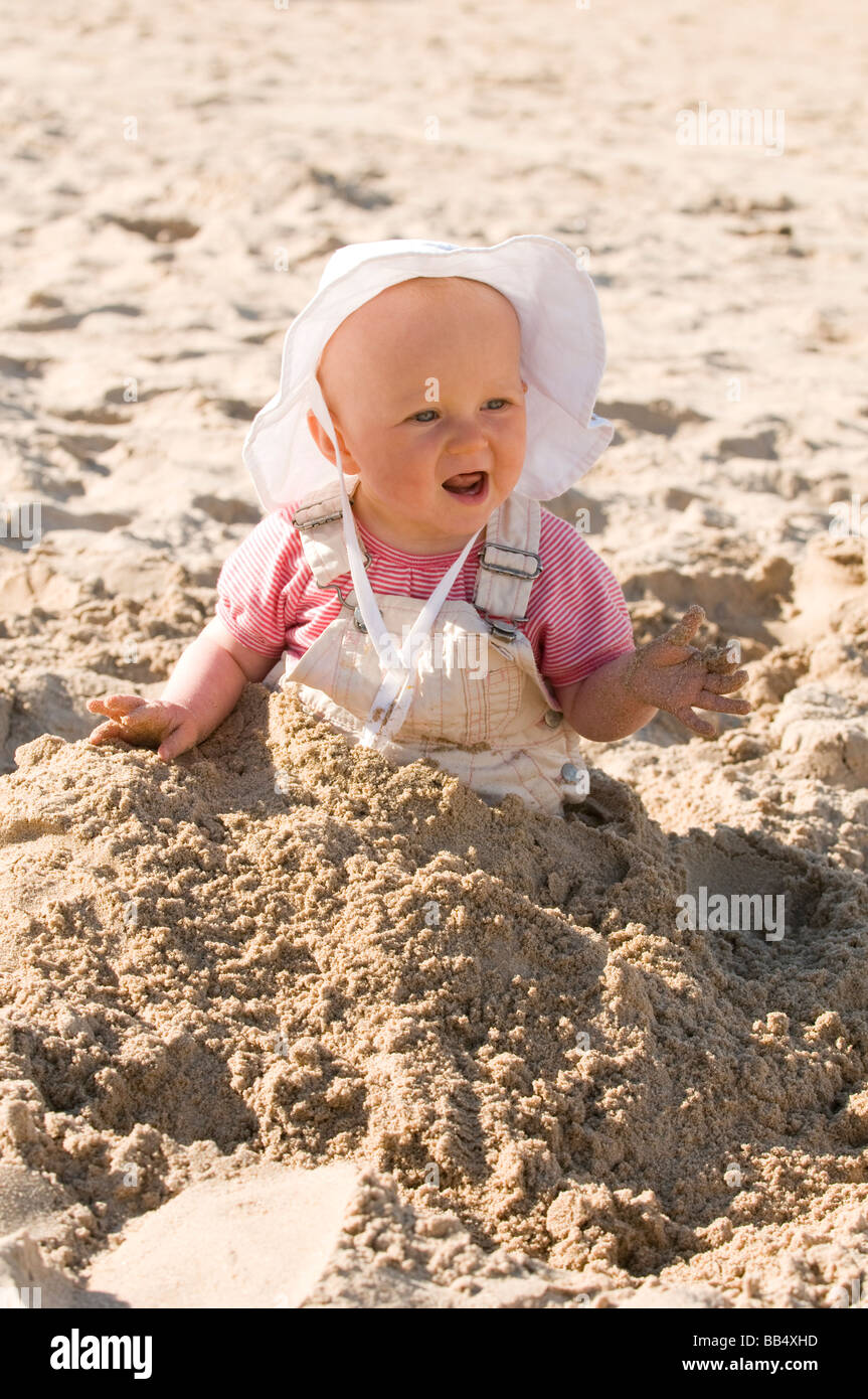 BABY GIRL, 9 MONTHS, PLAYING IN SAND ON THE BEACH. WHITE ROCKS BEACH