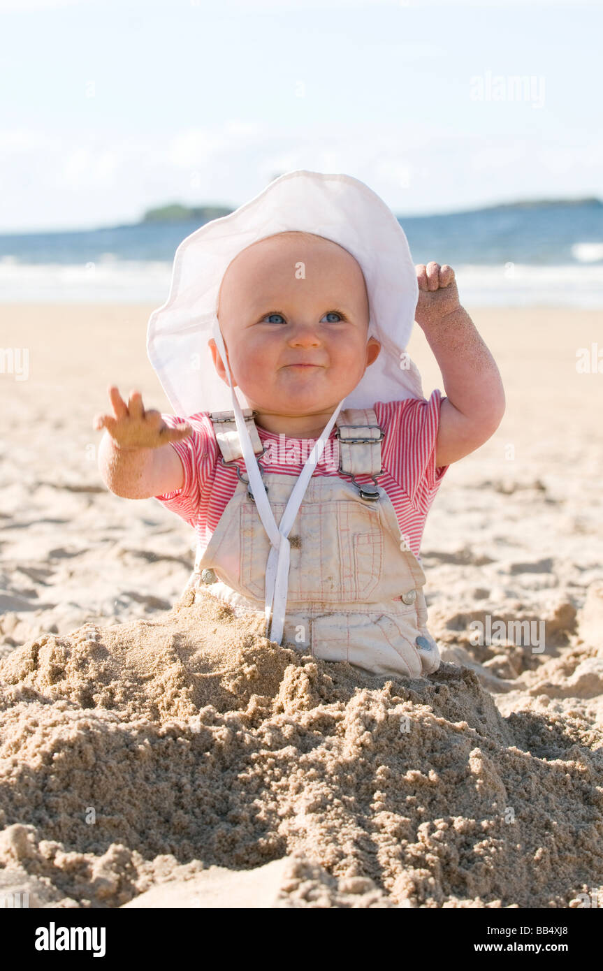BABY GIRL, 9 MONTHS, PLAYING IN SAND ON THE BEACH. WHITE ROCKS BEACH