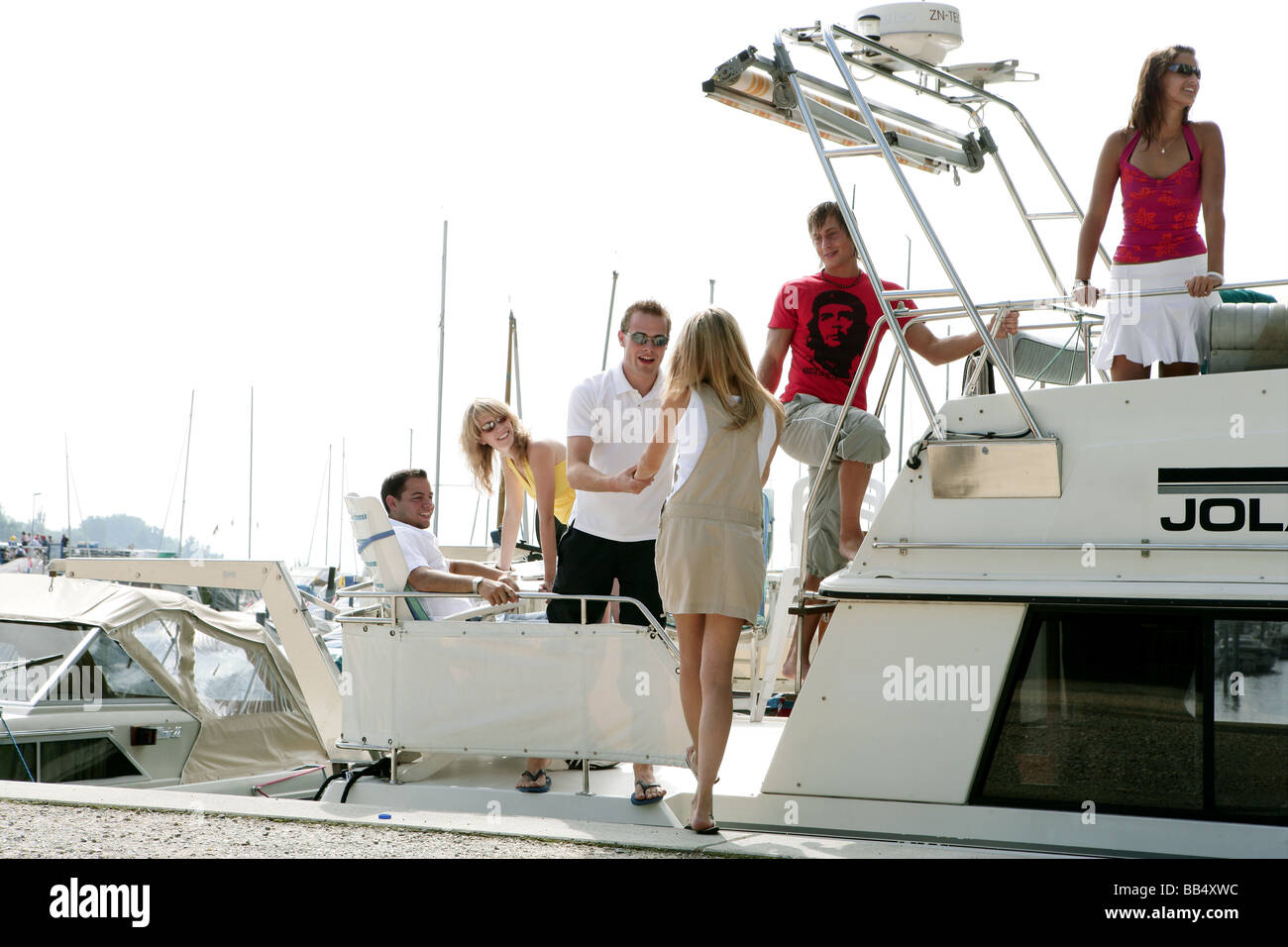 young group on a yacht in a port Stock Photo