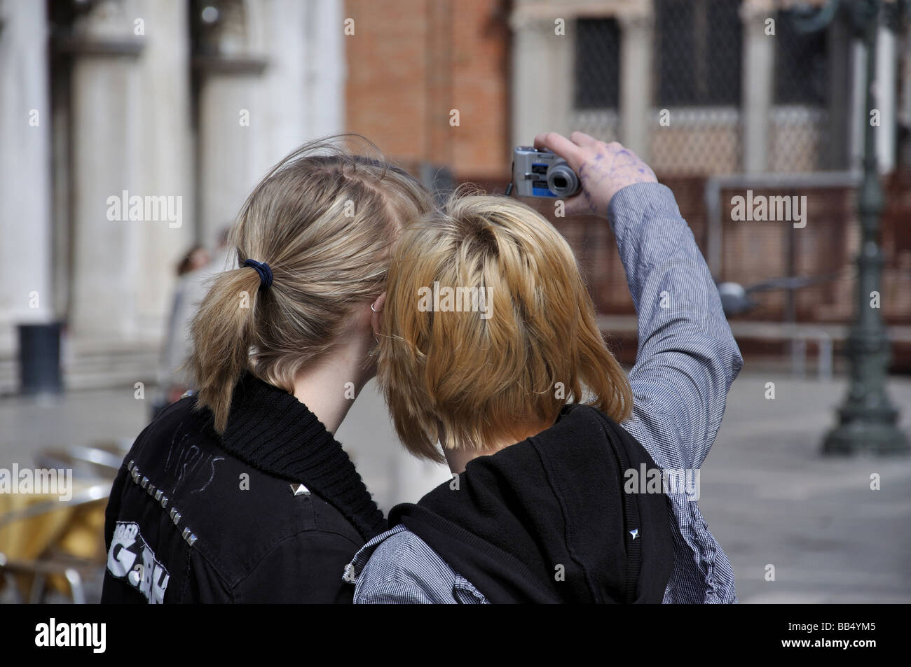 Girls taking photos of themselves, St Mark's Square, Venice, Venice Province, Veneto Region, Italy Stock Photo
