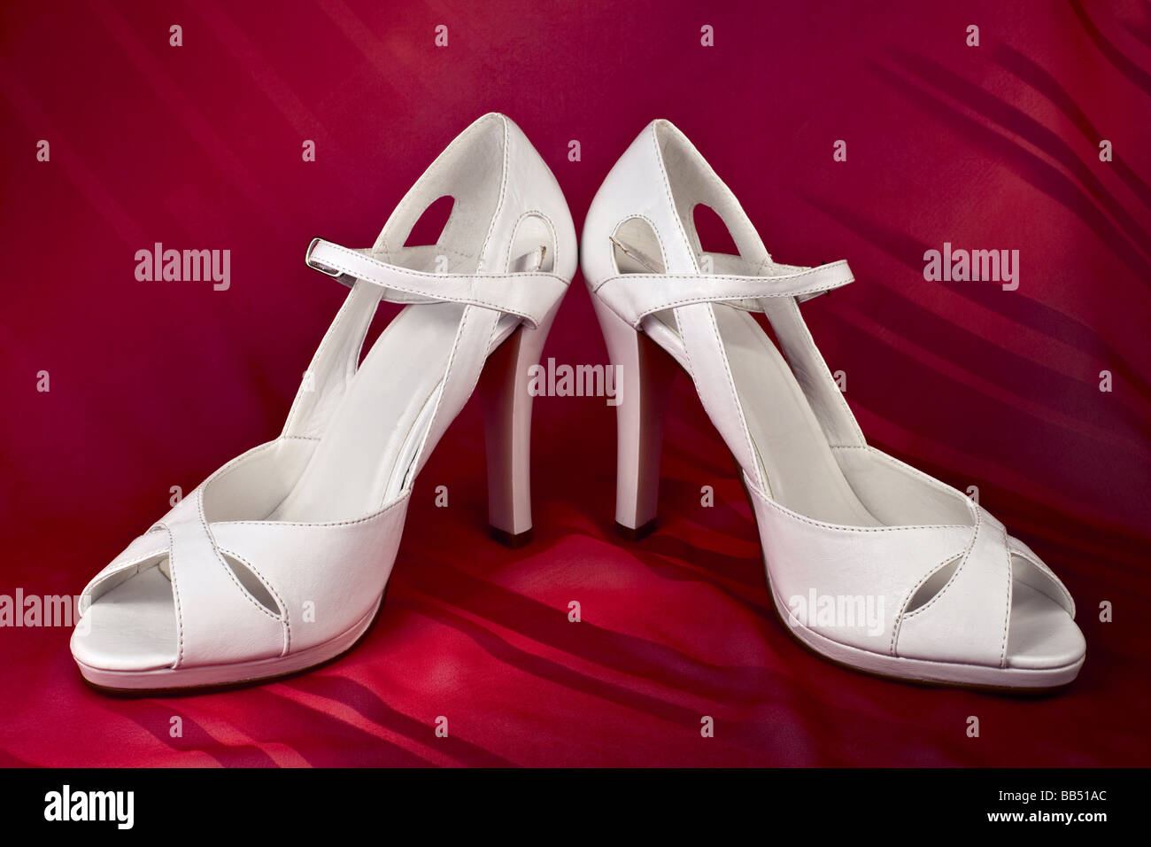 White high heeled shoes over red background Stock Photo - Alamy