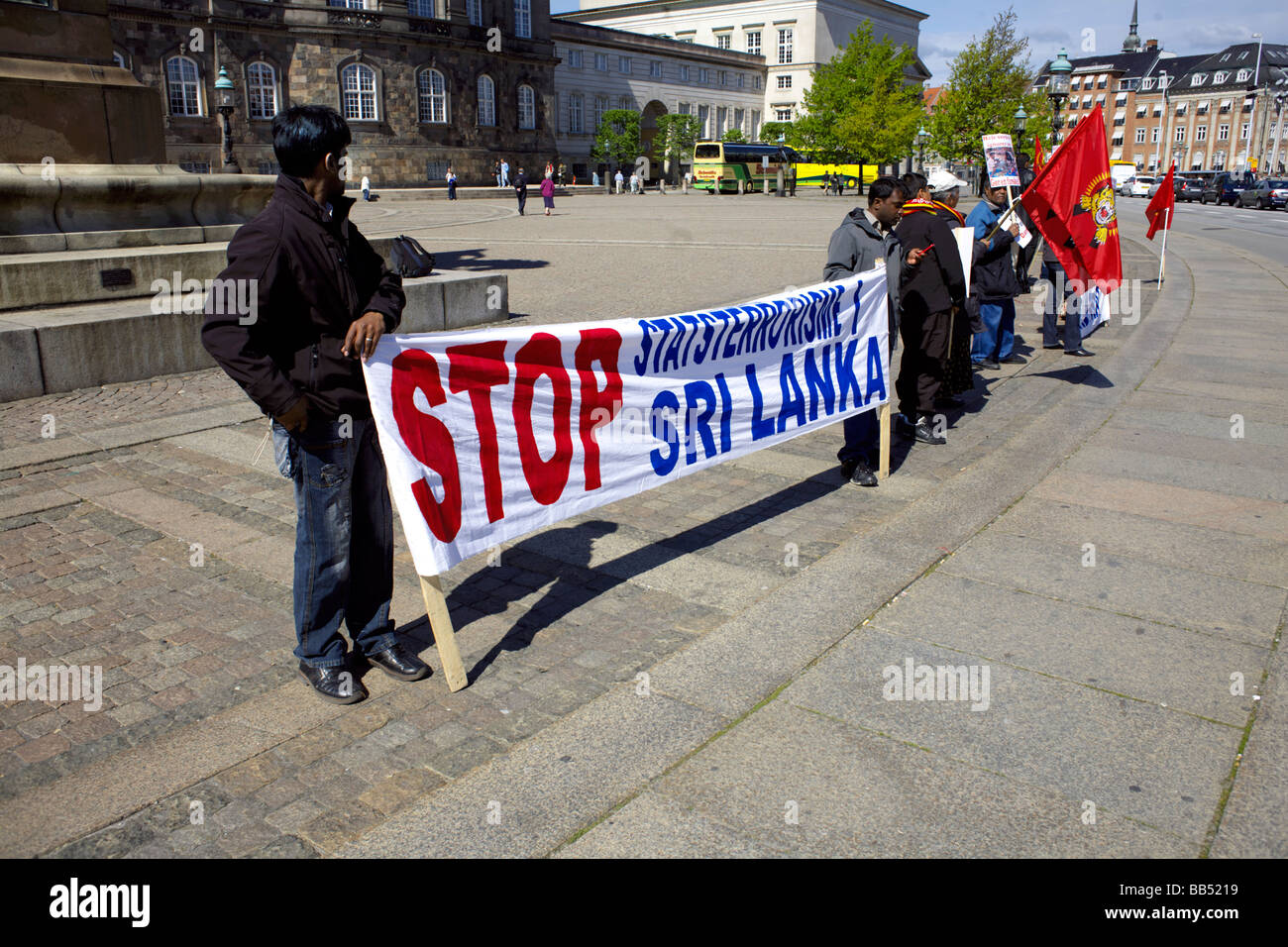 people holding placards at a 'Stop state terrorism in Sri Lanka' political protest outside the Christiansborg Palace, Copenhagen Stock Photo