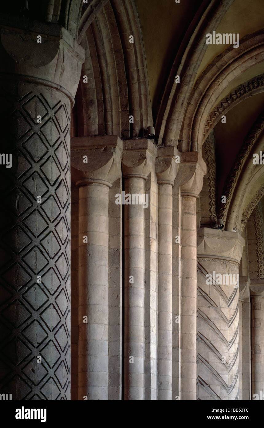Durham Cathedral Norman columns and capitals in the nave looking west along the north nave aisle Stock Photo