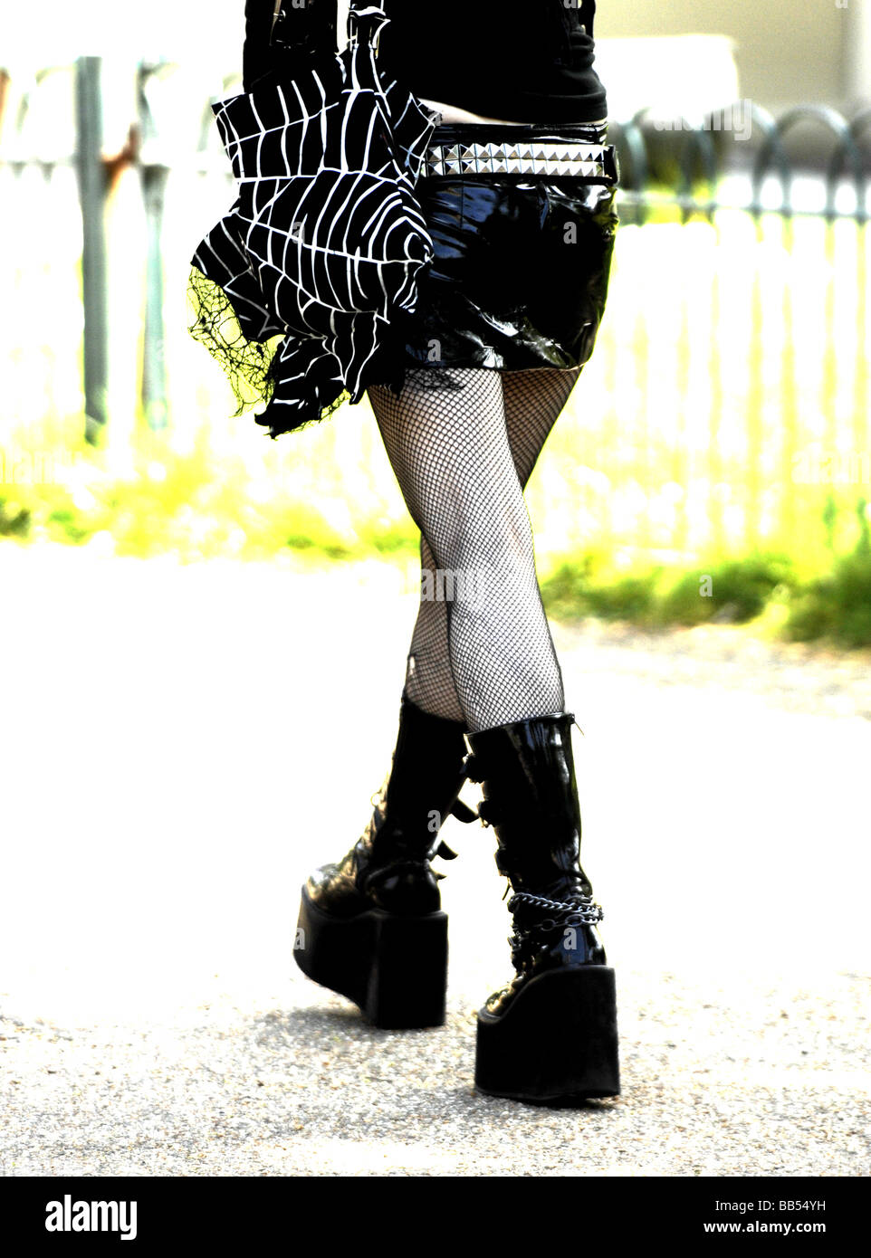 Female wearing huge platform boots and short black mini skirt with stockings Stock Photo