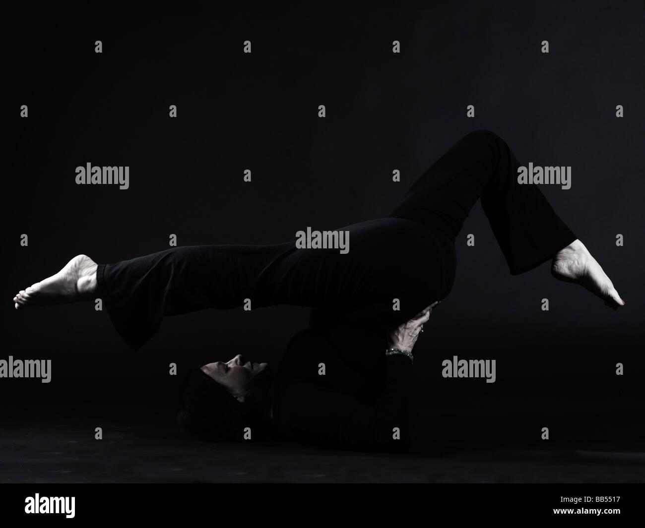 Halasana (Plow Pose) yoga Stock Photo - Alamy