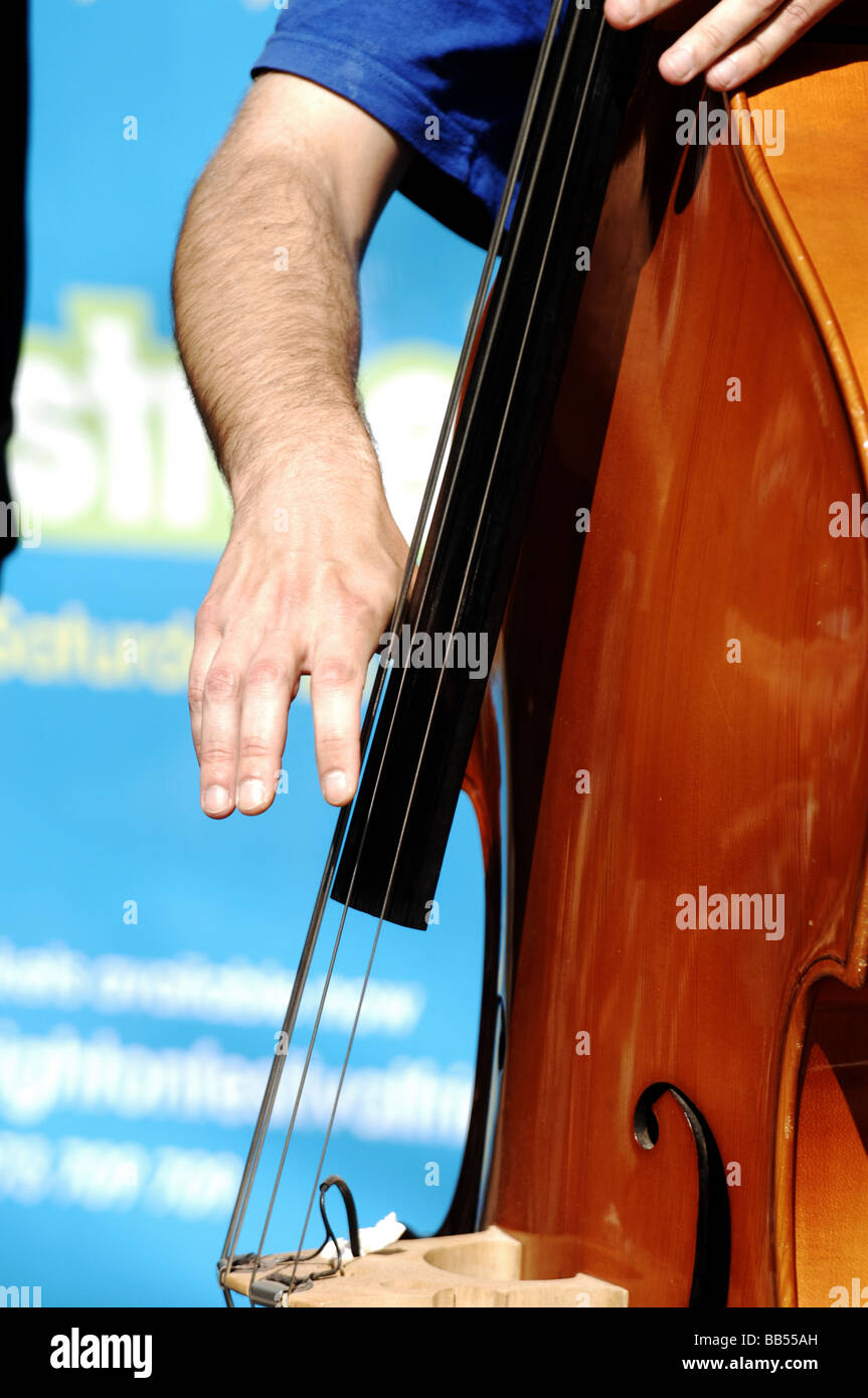 Man playing the double bass musical instrument at the Brighton Festival Stock Photo