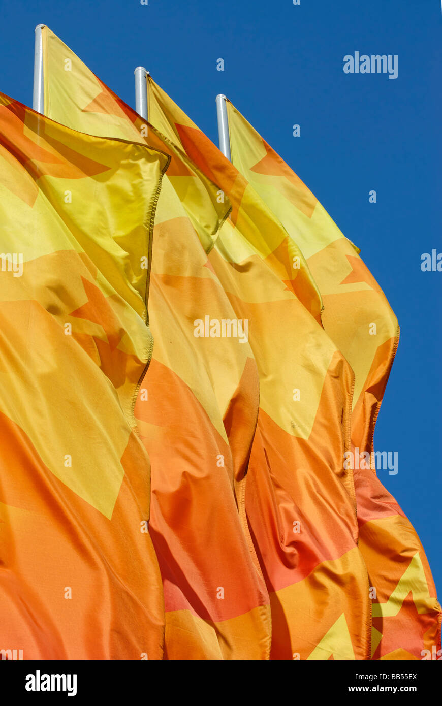 Celebratory orange flags on the blue sky background Stock Photo Alamy