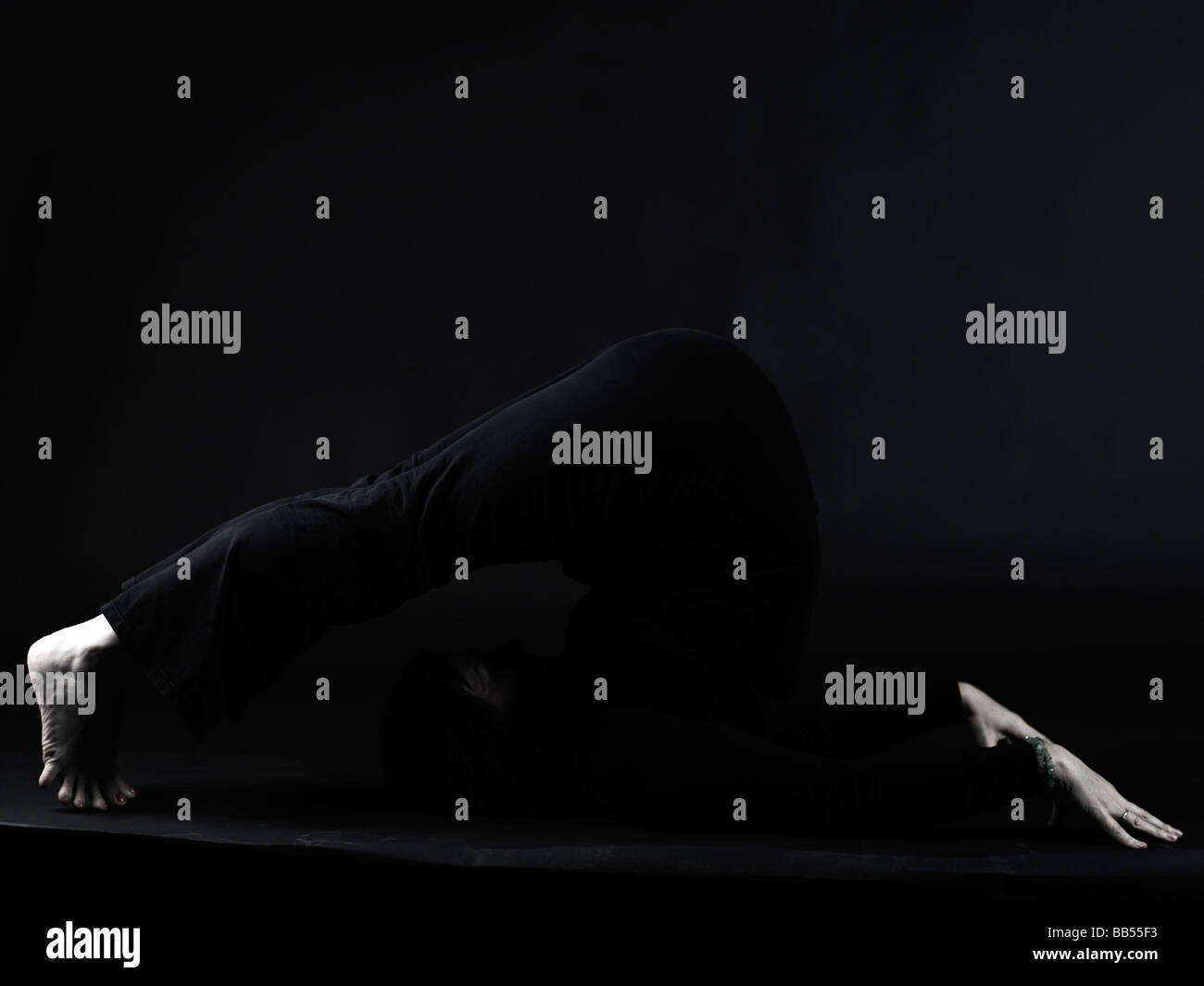 Halasana (Plow Pose) yoga Stock Photo - Alamy
