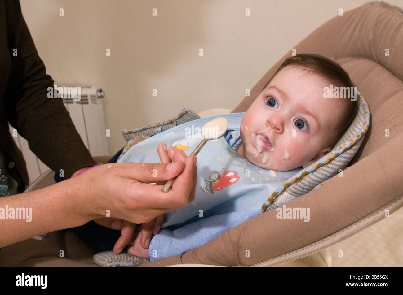 six month old baby eating baby food Stock Photo - Alamy