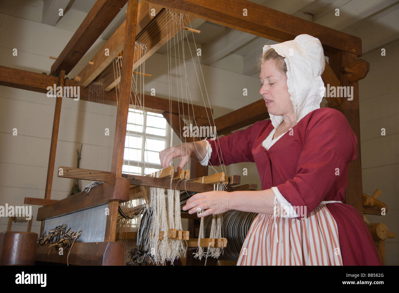 A period actor plays the role of a weaver in Colonial Williamsburg