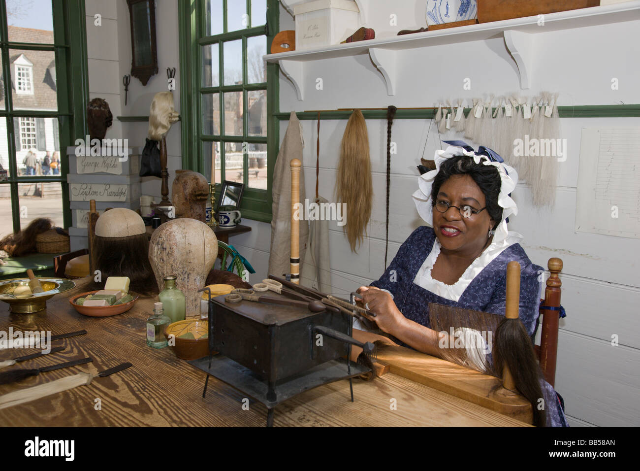 A woman makes a wig in the Barber & Peruke Maker Shop at Colonial