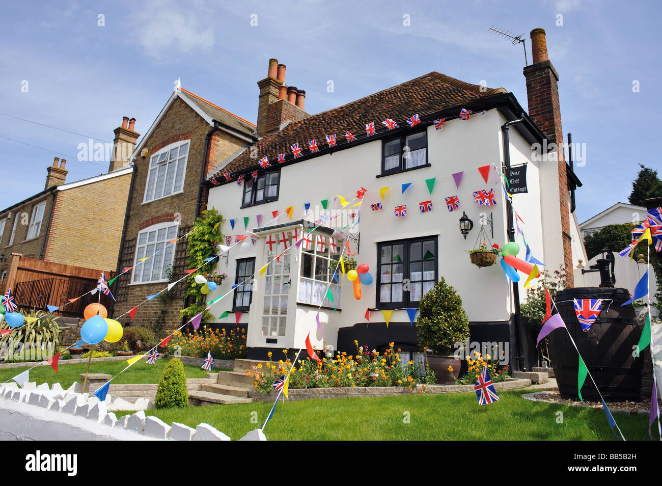 A cottage festooned with bunting and flags to celebrate Pratt Bottoms