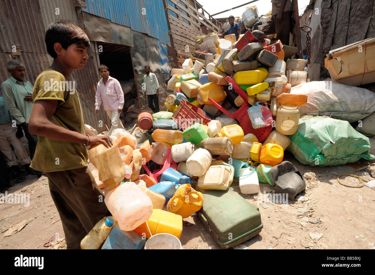 A young worker in Dharavi collecting and depositing plastic for recycling Stock Photo