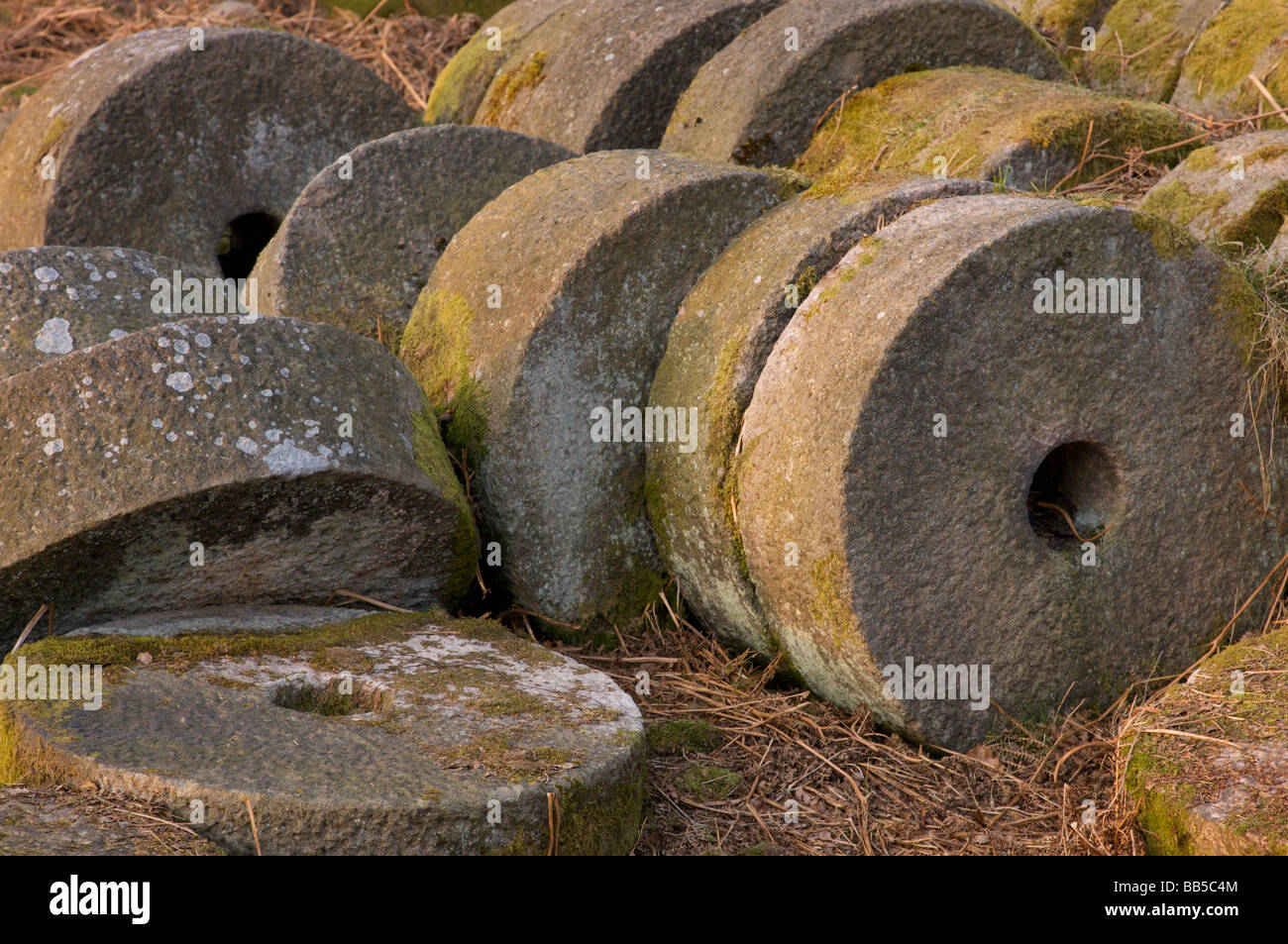 Abandoned millstones in Bolehill Quarry, Lawrencefield, Hathersage, Derbyshire Peak District Stock Photo