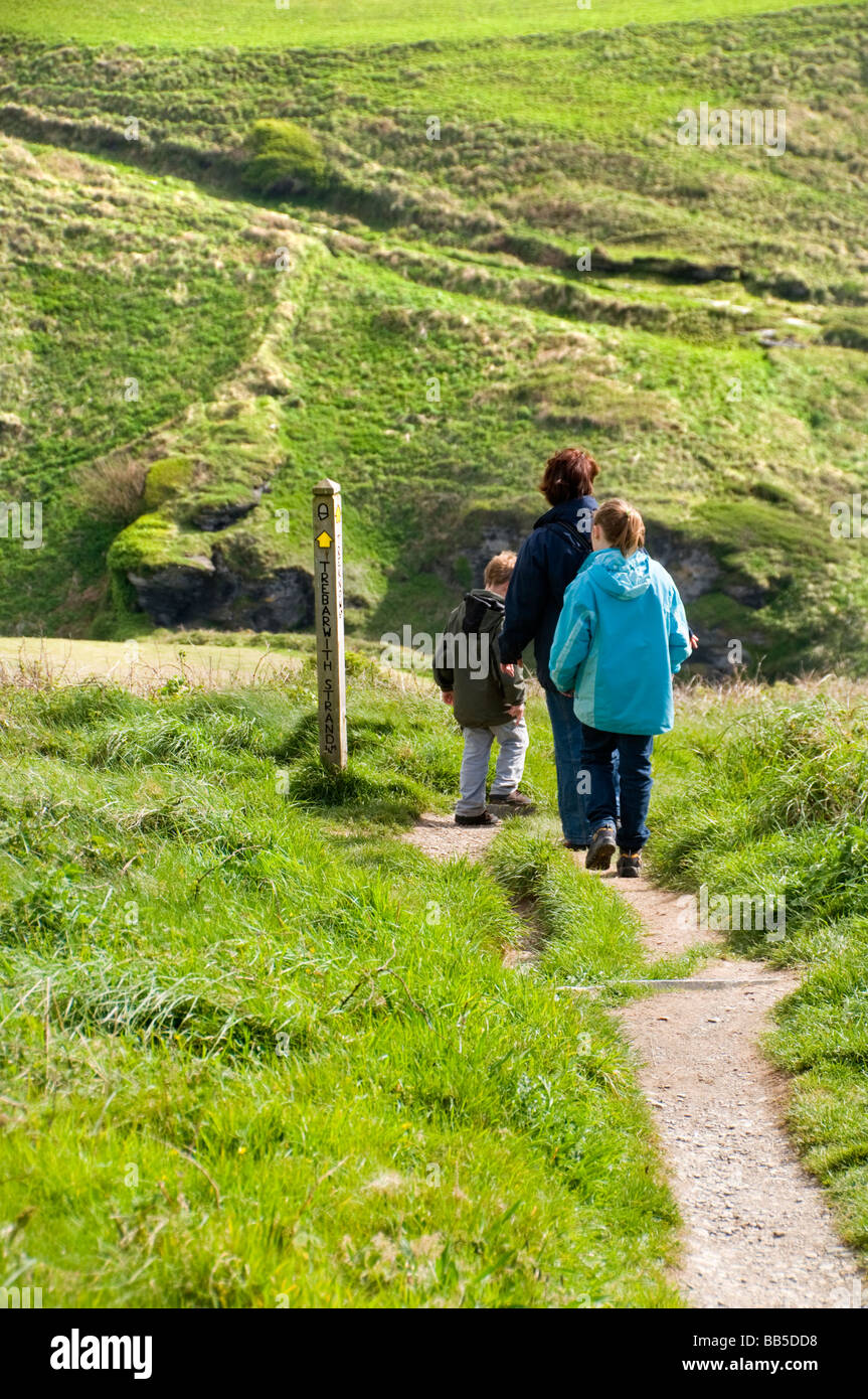 A family group walking along the South West Coast Path near Trebarwith Strand in Cornwall, England, UK Stock Photo