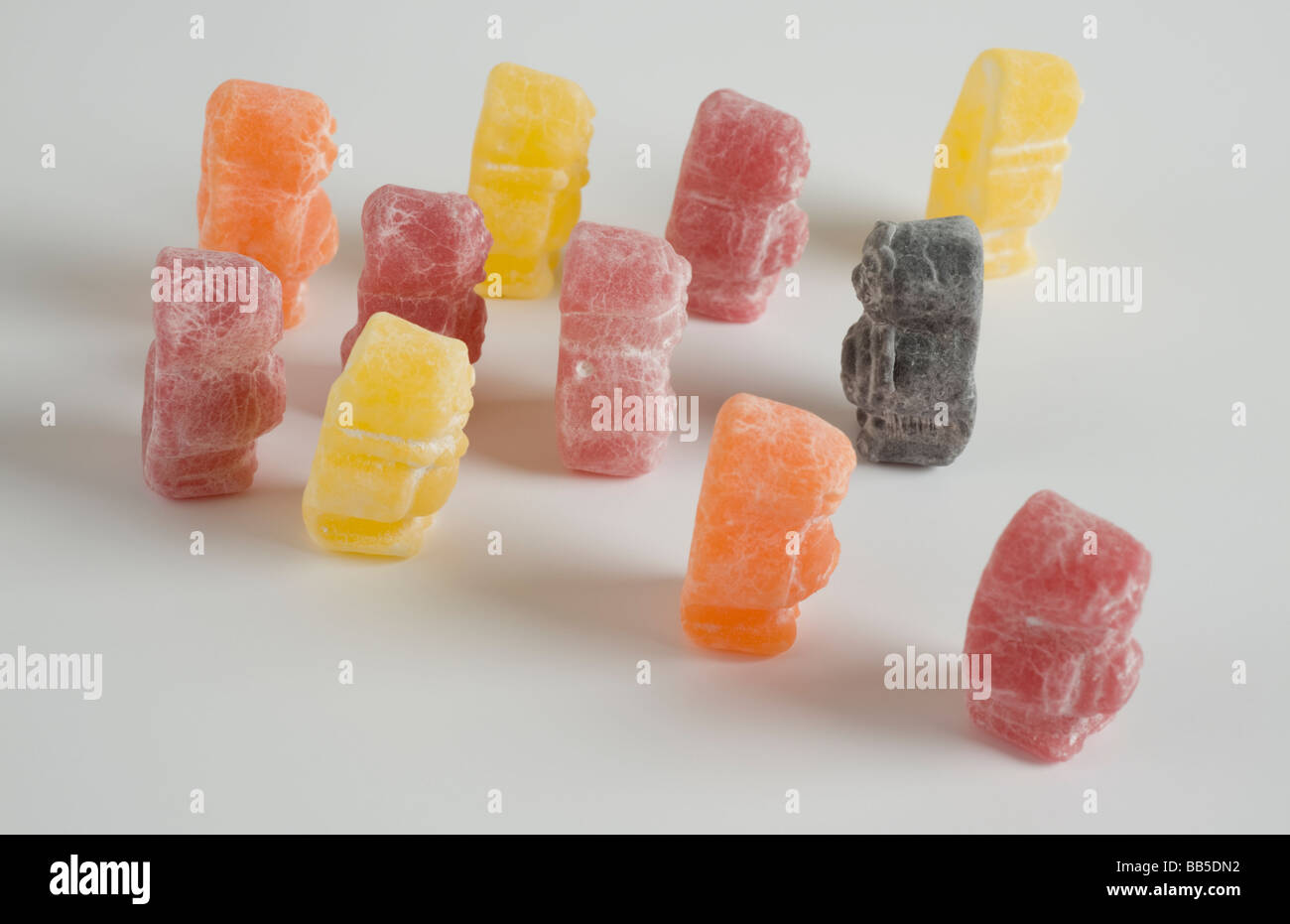 Black jelly baby walks through crowd travelling in opposite direction