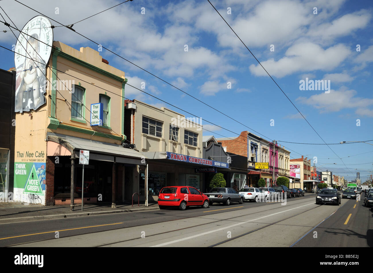 Typical suburban shops Lygon Street Carlton with tram lines Melbourne Australia Stock Photo