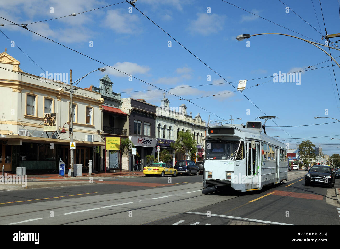 Typical suburban shops some with Victorian facades Lygon Street Carlton with tram lines Melbourne Australia Stock Photo