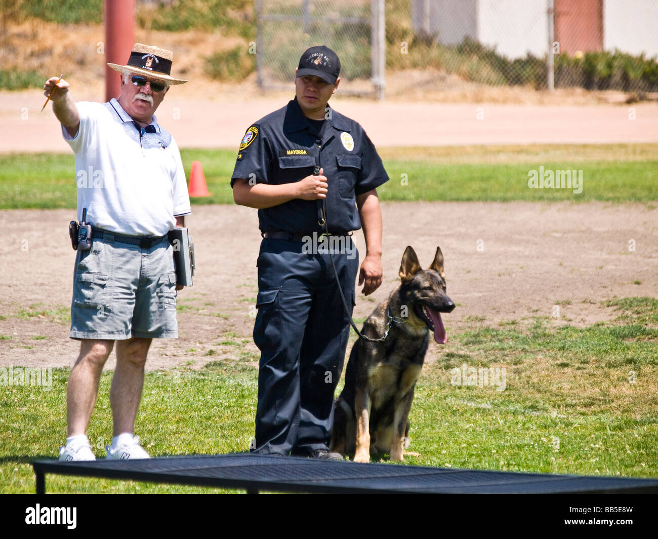 Police officer with dog get instructions from field judge at the k9 trials Stock Photo