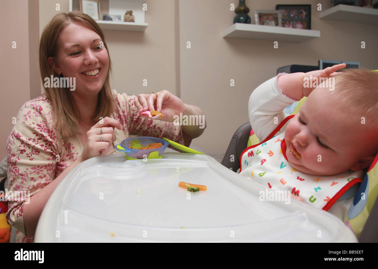 Mother feeding baby vegetables Stock Photo