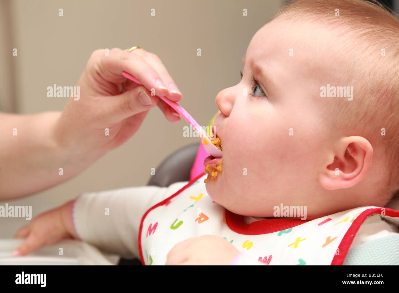 8 month old baby eating and drinking Stock Photo Alamy